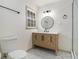 Bathroom featuring a modern vanity, toilet, shower, and decorative tile floors at 546 Milligan Dr, Stone Mountain, GA 30083