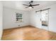 Bedroom with hardwood floors, a window, and a barn door leading to a bathroom at 546 Milligan Dr, Stone Mountain, GA 30083
