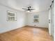 Bedroom with hardwood floors, two windows, and a sliding barn door at 546 Milligan Dr, Stone Mountain, GA 30083