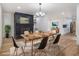 Dining room with fireplace and wood table next to stainless appliances and white cabinets at 546 Milligan Dr, Stone Mountain, GA 30083