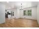 Bright dining room with hardwood floors, a modern chandelier, and sliding glass doors at 546 Milligan Dr, Stone Mountain, GA 30083