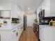 Updated kitchen featuring white cabinets, stainless steel appliances, and modern countertops at 546 Milligan Dr, Stone Mountain, GA 30083