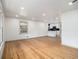 Living Room hardwood floors and large windows offering natural light with an adjoining kitchen at 546 Milligan Dr, Stone Mountain, GA 30083