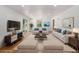 Staged living room features modern decor, a large window, and sliding glass doors at 546 Milligan Dr, Stone Mountain, GA 30083