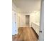 Bright bathroom featuring double sink vanity, modern finishes, wood-look flooring, and walk-in closet at 660 Redhead Way (Lot 24), Grayson, GA 30017