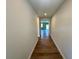 Hallway featuring hardwood floors and neutral-colored walls leading to rooms with natural light at 660 Redhead Way (Lot 24) Way, Grayson, GA 30017