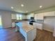 Bright kitchen with granite countertops, stainless steel appliances, and an island at 660 Redhead Way (Lot 24), Grayson, GA 30017