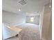 This carpeted loft has a light wall color and a large window offering natural light at 660 Redhead Way (Lot 24), Grayson, GA 30017