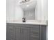 Bathroom featuring a gray vanity with a quartz countertop and modern fixtures at 7437 Nulan Way, Riverdale, GA 30274