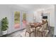 Cozy dining room with patio access, a modern light fixture and wood-look flooring at 7437 Nulan Way, Riverdale, GA 30274