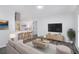 Bright, open living room with modern furniture, a breakfast bar and stainless steel range hood at 7437 Nulan Way, Riverdale, GA 30274