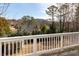 View of a lush backyard from a white-railed deck, showcasing mature trees and landscaping at 764 Sharpshooters Nw Rdg, Marietta, GA 30064