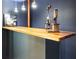 Close up of finished basement bar featuring wood top bar, custom fixtures, and bar tending set at 764 Sharpshooters Nw Rdg, Marietta, GA 30064
