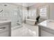 Bright bathroom features a soaking tub, glass shower, double vanity, and marble tile at 764 Sharpshooters Nw Rdg, Marietta, GA 30064