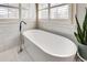 Bright bathroom showcasing a modern soaking tub with views from two large windows at 764 Sharpshooters Nw Rdg, Marietta, GA 30064