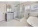 Elegant bathroom featuring a glass shower, soaking tub, and stylish gray vanity at 764 Sharpshooters Nw Rdg, Marietta, GA 30064