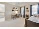 Well-lit bedroom with a desk, helmets on the wall, and neutral carpet throughout at 764 Sharpshooters Nw Rdg, Marietta, GA 30064