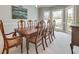 A formal dining room featuring a large wood table set, crown molding, and lots of natural light from the bay windows at 764 Sharpshooters Nw Rdg, Marietta, GA 30064