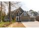 Charming two-story home with a stone and siding exterior, three-car garage and well-manicured landscaping at 764 Sharpshooters Nw Rdg, Marietta, GA 30064