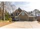 Charming two-story home with a stone and siding exterior, three-car garage and well-manicured landscaping at 764 Sharpshooters Nw Rdg, Marietta, GA 30064