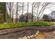 View of this house from across the street with mature trees in the front yard, showcasing landscaping at 764 Sharpshooters Nw Rdg, Marietta, GA 30064