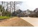 Beautiful two-story home with a spacious driveway, three-car garage and a stone retaining wall along the lawn at 764 Sharpshooters Nw Rdg, Marietta, GA 30064