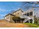 Rear exterior view of the home featuring a two-story deck and stairs to the stone-accented lower level at 764 Sharpshooters Nw Rdg, Marietta, GA 30064