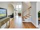 Elegant home foyer featuring hardwood floors, staircase, and views into the living room beyond at 764 Sharpshooters Nw Rdg, Marietta, GA 30064
