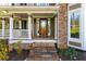 Cozy covered front porch with stone steps leading up to an elegant wood front door at 764 Sharpshooters Nw Rdg, Marietta, GA 30064