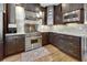 A modern kitchen featuring stainless steel appliances, granite countertops, and dark cabinetry with a tile backsplash at 764 Sharpshooters Nw Rdg, Marietta, GA 30064