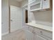 Finished basement kitchenette with white countertops, cabinets, microwave and a doorway at 764 Sharpshooters Nw Rdg, Marietta, GA 30064