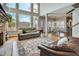 Bright living room boasts large windows with scenic views and a stone fireplace at 764 Sharpshooters Nw Rdg, Marietta, GA 30064