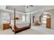 Spacious bedroom features a four-poster bed, sitting area, neutral decor, and ample natural light at 764 Sharpshooters Nw Rdg, Marietta, GA 30064