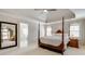 Tranquil main bedroom with a four-poster bed, tray ceiling, and bright windows at 764 Sharpshooters Nw Rdg, Marietta, GA 30064