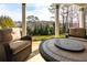 Covered patio featuring a fire pit and cozy seating, framed by scenic views and manicured landscaping at 764 Sharpshooters Nw Rdg, Marietta, GA 30064