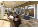 Covered patio showcasing outdoor seating around a fire pit table with stone flooring and ceiling fans at 764 Sharpshooters Nw Rdg, Marietta, GA 30064