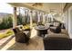 Covered patio area with stone flooring, ceiling fans, and comfortable seating arrangement and a picnic table at 764 Sharpshooters Nw Rdg, Marietta, GA 30064