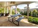 Covered patio with stone flooring, ceiling fans, picnic table and outdoor seating arrangement at 764 Sharpshooters Nw Rdg, Marietta, GA 30064