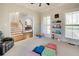 Spacious playroom with neutral walls, stairway view, natural light, and comfortable seating for play time at 764 Sharpshooters Nw Rdg, Marietta, GA 30064