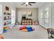 Bright and airy playroom with neutral walls, a ceiling fan, shelving, and access to the deck at 764 Sharpshooters Nw Rdg, Marietta, GA 30064