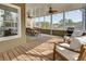 Inviting screened porch with wood floors, ceiling fans, a dining table and comfortable seating at 764 Sharpshooters Nw Rdg, Marietta, GA 30064