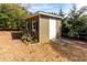 Outdoor storage shed featuring natural siding and convenient walk-up concrete ramp at 764 Sharpshooters Nw Rdg, Marietta, GA 30064