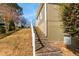 Stone stairs lead to the home's side entrance, accented by natural landscaping and a side yard at 764 Sharpshooters Nw Rdg, Marietta, GA 30064