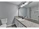 Modern bathroom featuring granite countertop, framed mirror, and tiled walk-in shower at 2773 Marcia Dr, Lawrenceville, GA 30044