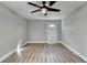 Bedroom featuring wood-look flooring, ceiling fan, and a front-facing window at 2773 Marcia Dr, Lawrenceville, GA 30044