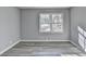 Well-lit bedroom features a double window and grey wood-look flooring at 2773 Marcia Dr, Lawrenceville, GA 30044