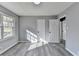 Relaxing bedroom with neutral gray walls, plank flooring, and a bright window providing natural light at 2773 Marcia Dr, Lawrenceville, GA 30044