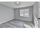 Serene bedroom with gray walls, plank flooring, and a large window offering abundant natural light at 2773 Marcia Dr, Lawrenceville, GA 30044