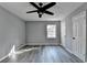 Spacious bedroom with grey wood-look flooring, ceiling fan, and two closets at 2773 Marcia Dr, Lawrenceville, GA 30044