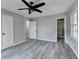 Bedroom featuring updated gray wood-look floors, ceiling fan and a bathroom at 2773 Marcia Dr, Lawrenceville, GA 30044